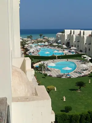 a view of the pool from the balcony of a resort at Gravity Apartment 410 beautiful apartment with view in structure Gravity Sahl Hasheesh -No Egyptian Passports in Hurghada