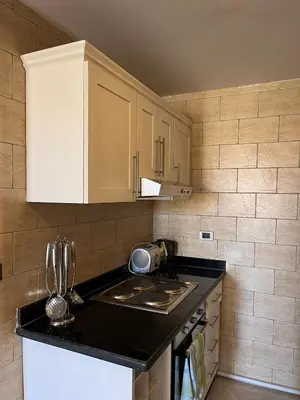 a kitchen with a stove and a counter top at Gravity Apartment 410 beautiful apartment with view in structure Gravity Sahl Hasheesh -No Egyptian Passports in Hurghada