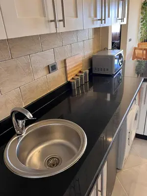 a kitchen counter with a sink and a microwave at Gravity Apartment 410 beautiful apartment with view in structure Gravity Sahl Hasheesh -No Egyptian Passports in Hurghada