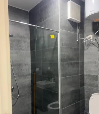 a bathroom with a glass shower with a sink at 412atthepavilionimperialHurghada in Hurghada