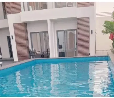 a swimming pool in front of a house at 412atthepavilionimperialHurghada in Hurghada