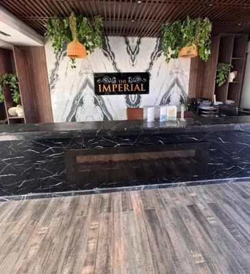 a bar in a restaurant with a black counter top at 412atthepavilionimperialHurghada in Hurghada
