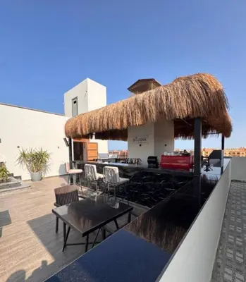 a rooftop bar with a straw roof at 412atthepavilionimperialHurghada in Hurghada