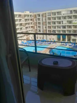 a view of a swimming pool from the balcony of a hotel at Pearl of Tiba Golden Resort in Hurghada