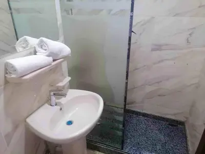 a bathroom with a toilet and a sink and a shower at Pearl of Tiba Golden Resort in Hurghada