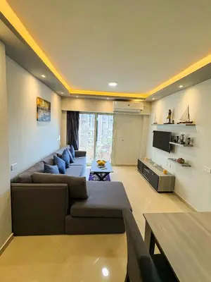 a living room with a couch and a tv at Amazing View! Beach Access & Pool Hurghada in Hurghada