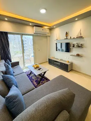 a living room with a couch and a tv at Amazing View! Beach Access & Pool Hurghada in Hurghada