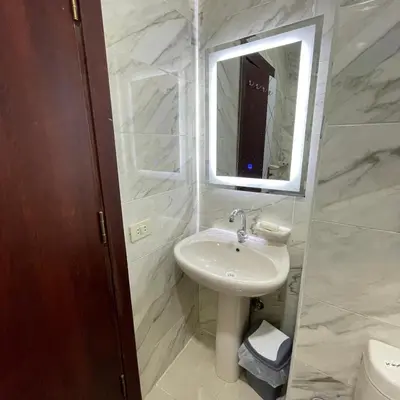 a white bathroom with a sink and a mirror at Tiba Golden Resort Hurghada in Hurghada