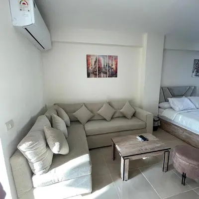 a living room with a couch and a bed at Tiba Golden Resort Hurghada in Hurghada