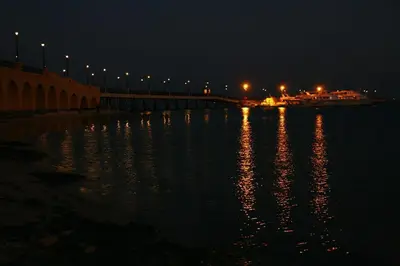 a bridge over a body of water at night at 310 el Andalous Apartment in Hurghada