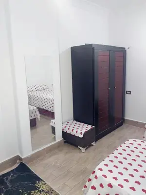 a room with a mirror and a bed and a chair at Economy Onebedroom Apartment Hurghada in Hurghada