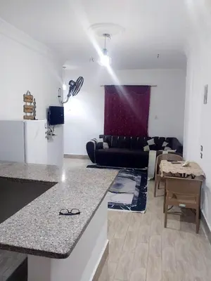 a kitchen and living room with a couch and a table at Economy Onebedroom Apartment Hurghada in Hurghada