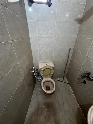 a small bathroom with a toilet in a stall at Nubian Dreams guest house 2 in Aswan