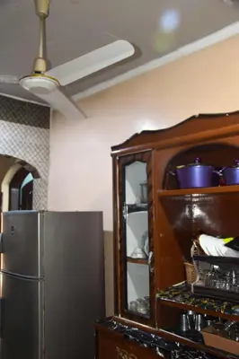 a kitchen with a refrigerator and a cabinet at golden mountain apartments in ‘Ezbet Abu Ḥabashi