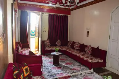 a living room with red couches in a room at golden mountain apartments in ‘Ezbet Abu Ḥabashi