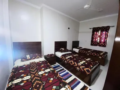 a bedroom with two beds and a window in it at nubian yellow desert in Aswan