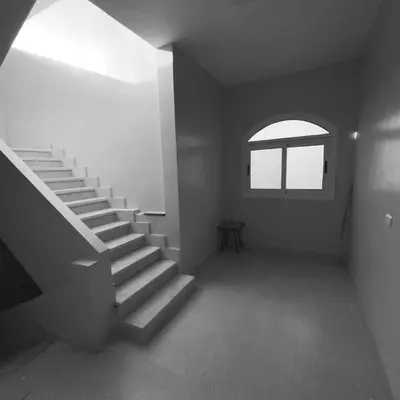 an empty room with stairs and a window at nubian yellow desert in Aswan