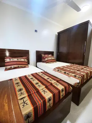 two beds sitting next to each other in a room at nubian yellow desert in Aswan
