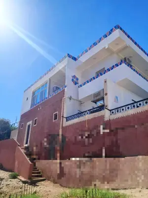 a house that is on top of a brick wall at nubian yellow desert in Aswan