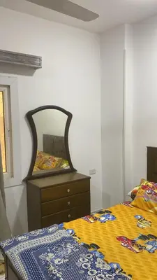 a bedroom with a bed and a dresser and a mirror at الغردقة - القيادات - بالقرب من سيتي سنتر مول و شاطئ الجيش in Hurghada