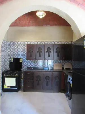 a kitchen with a stove with a bunch of symbols on the wall at Lovely Private Villa in Luxor