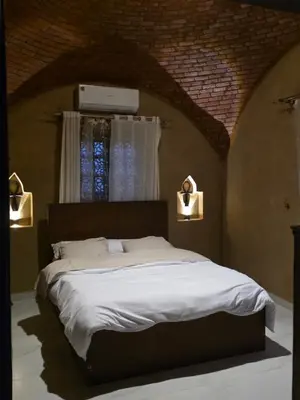 a bedroom with a large white bed with a window at Lovely Private Villa in Luxor