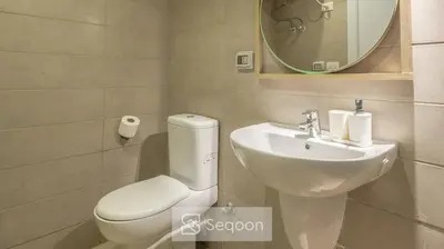 a bathroom with a toilet and a sink and a mirror at Serenity Studio in G-Cribs in El Gouna