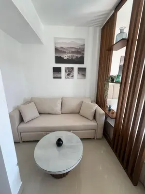 a living room with a couch and a table at Serenity Studio in G-Cribs in El Gouna