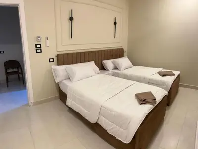 two beds in a hotel room with at ElMena House Luxor in Luxor