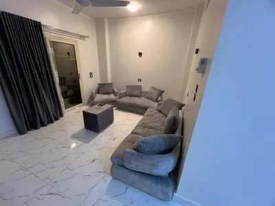 a living room with a couch and a table at ElMena House Luxor in Luxor