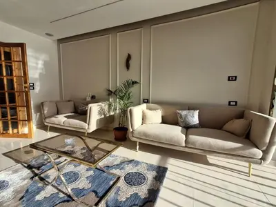 a living room with two couches and a table at ElMena House Luxor in Luxor