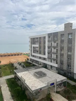 an external view of a large building with a field at Fanadir bay in Hurghada