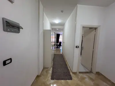 a hallway with white walls and a carpet at شاليه اوزيس Oasis Chalet in New cairo