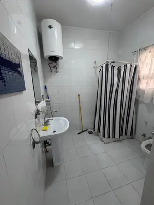 a white bathroom with a sink and a toilet at شاليه اوزيس Oasis Chalet in New cairo