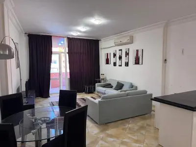 a living room with a couch and a glass table at شاليه اوزيس Oasis Chalet in New cairo