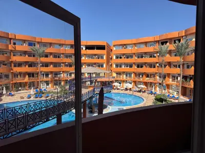 a view of the pool from the balcony of a hotel at شاليه اوزيس Oasis Chalet in New cairo