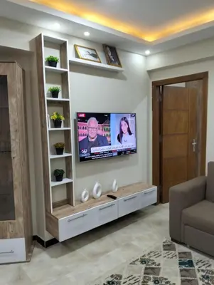 a living room with a flat screen tv on a wall at كومباوند البرنسيسه in Hurghada