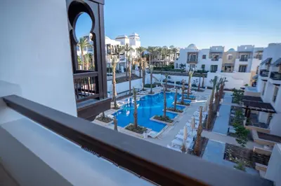 a view of the pool from the balcony of a hotel at Ancient Sands El Gouna Hurghada in Hurghada