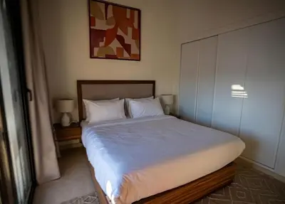 a bedroom with a large bed with white sheets at Ancient Sands El Gouna Hurghada in Hurghada