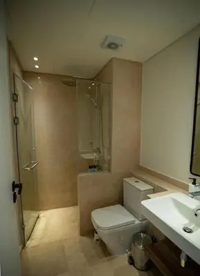 a bathroom with a shower and a toilet and a sink at Ancient Sands El Gouna Hurghada in Hurghada