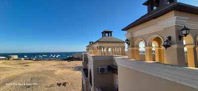 a building with a view of a beach and the ocean at Modern studio with sea view und large roof terrace in Hurghada