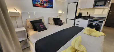 a bedroom with a large bed with towels on it at Modern studio with sea view und large roof terrace in Hurghada