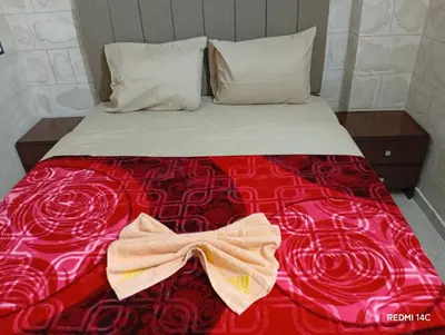a bed with a red blanket with a bow on it at Sugar Nubian Guest House Nile Vew in Aswan