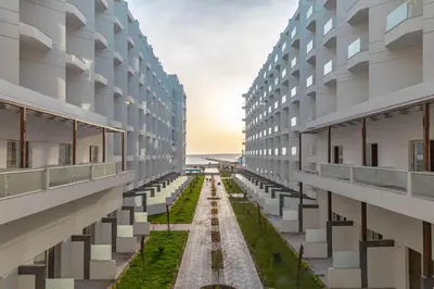 an empty building with grass between two buildings at One bedroom Chalet Scandic Resort Hurghada in Hurghada