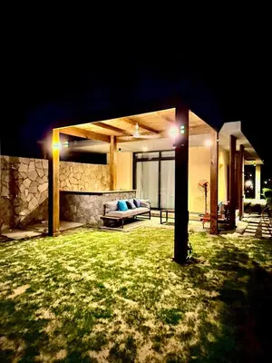 a house with a couch in a yard at night at Luxury 1 BR apartment with garden, Mesca - Somabay in Hurghada