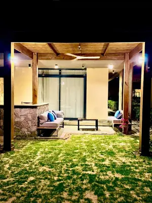 a patio with a couch and a table in a yard at Luxury 1 BR apartment with garden, Mesca - Somabay in Hurghada