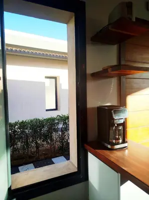 a window in a kitchen with a coffee maker on a counter at Luxury 1 BR apartment with garden, Mesca - Somabay in Hurghada