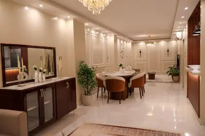 a dining room with a table and chairs and a mirror at Cozy Luxe Apartment in Central Aswan in Aswān