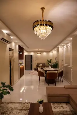 a dining room and living room with a chandelier at Cozy Luxe Apartment in Central Aswan in Aswān