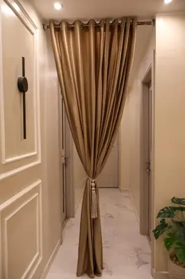 a curtain in a hallway next to a door at Cozy Luxe Apartment in Central Aswan in Aswān